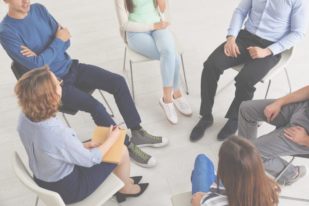 People at group psychotherapy session indoors